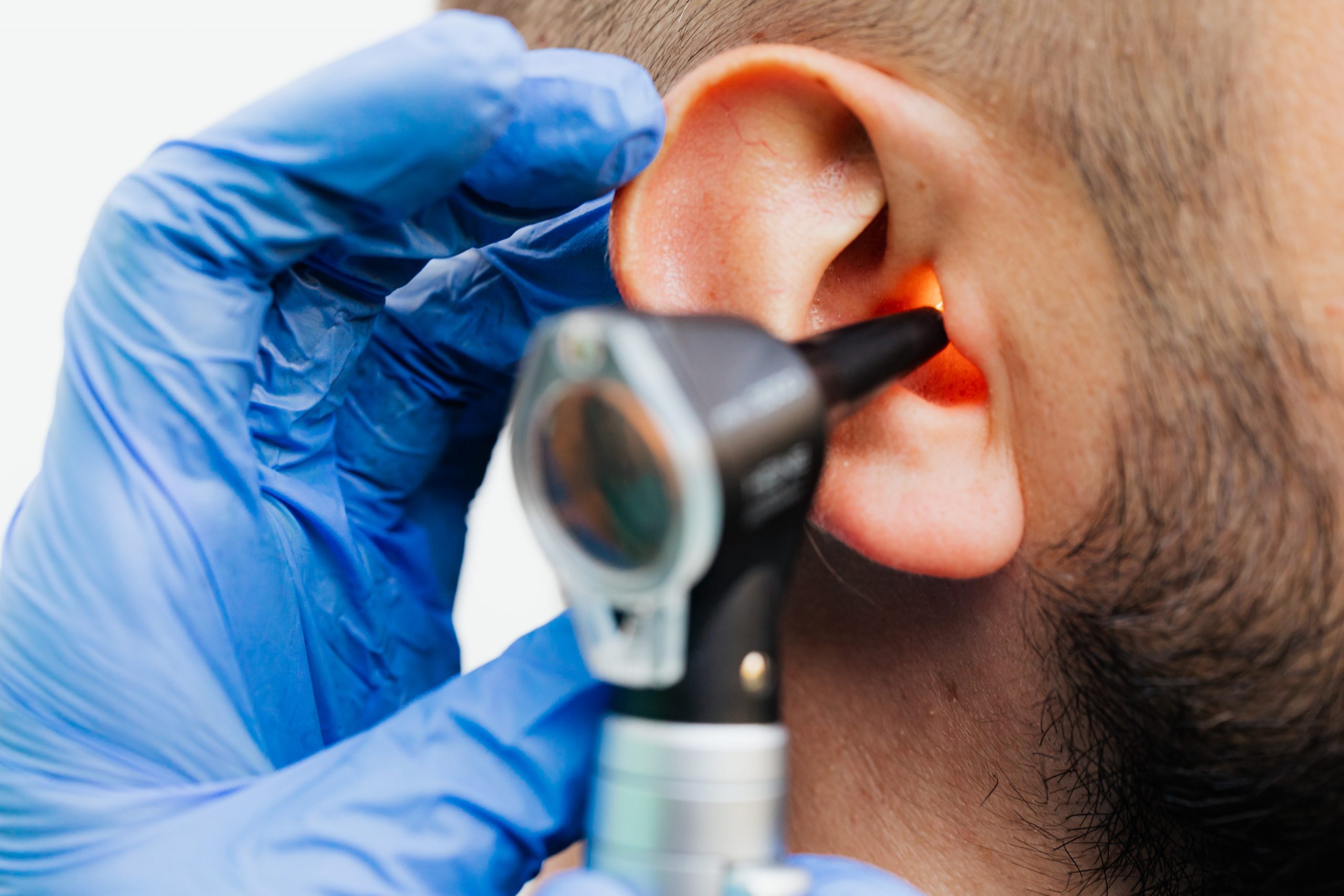 audiologist examining someone's ear
